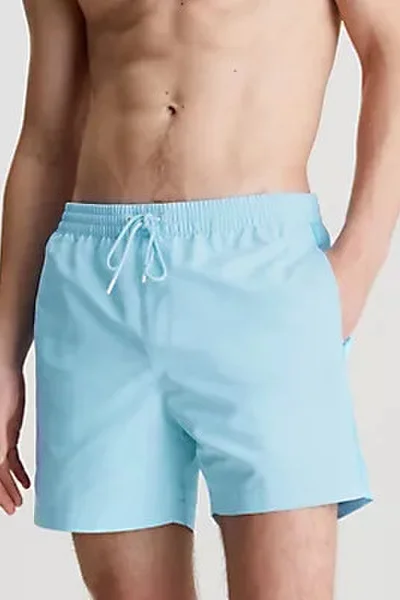 Světle modré pánské koupací šortky Calvin Klein S - 4XL