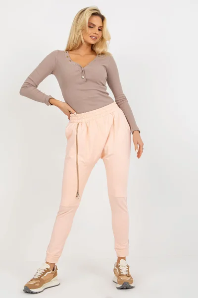 Světle růžové dámské tepláky s úzkými nohavicemi Ex Moda